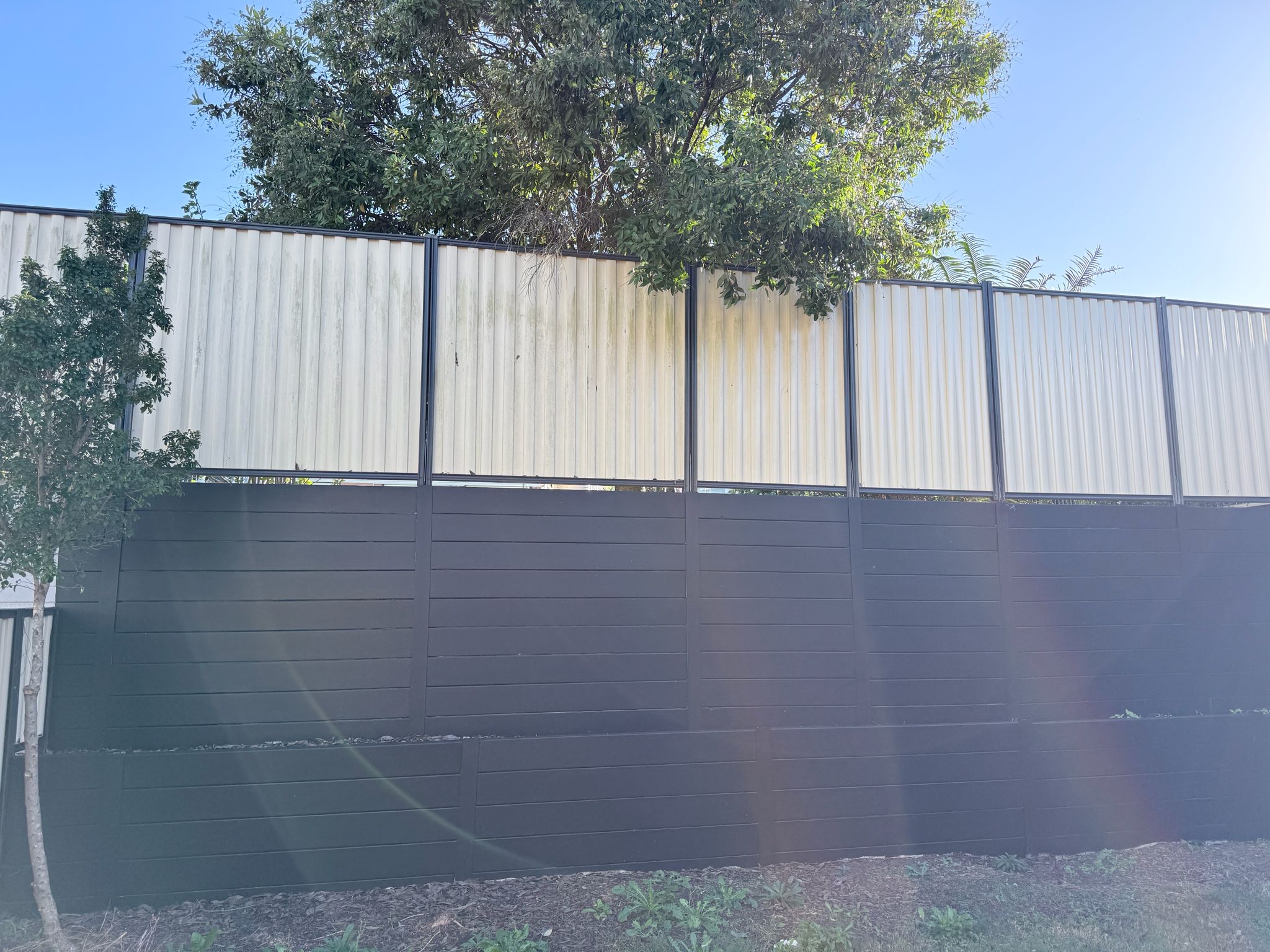 Fence painting Brisbane — dark charcoal colorbond finish by Paintmates